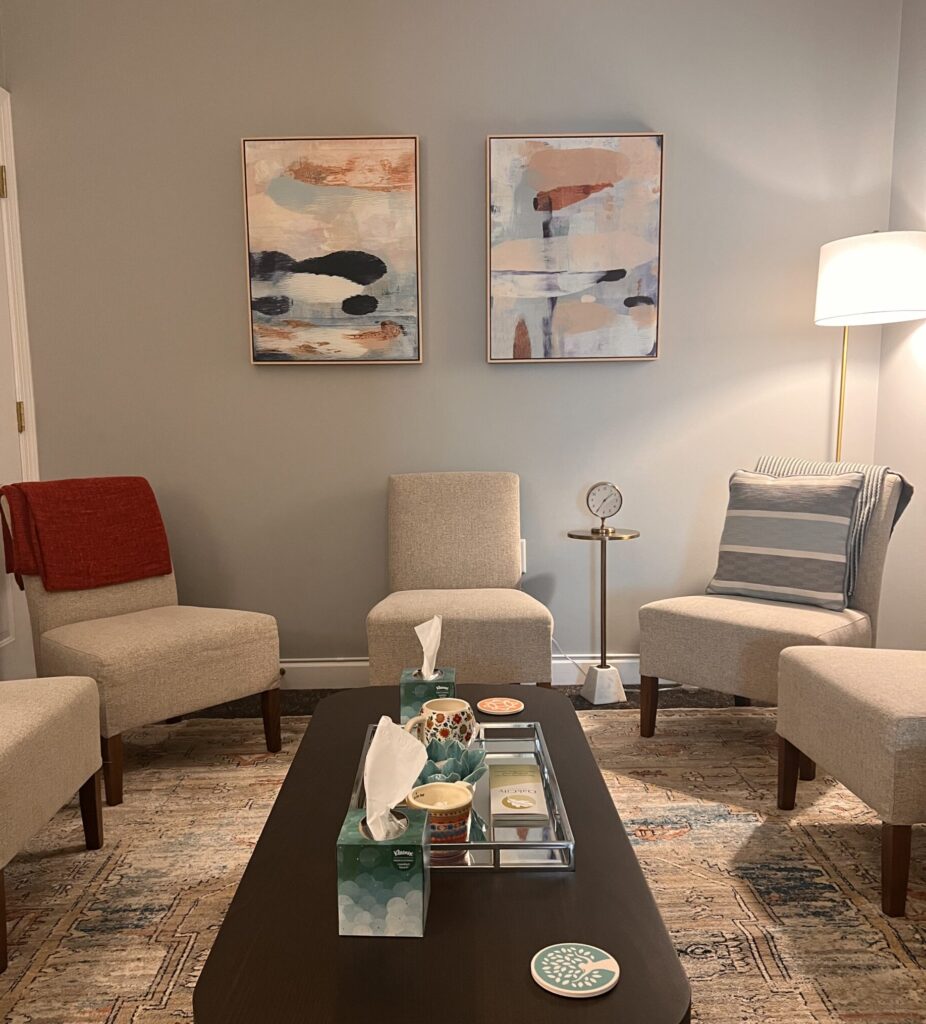 Professional and streamlined room with minimalist chairs and abstract paintings on wall